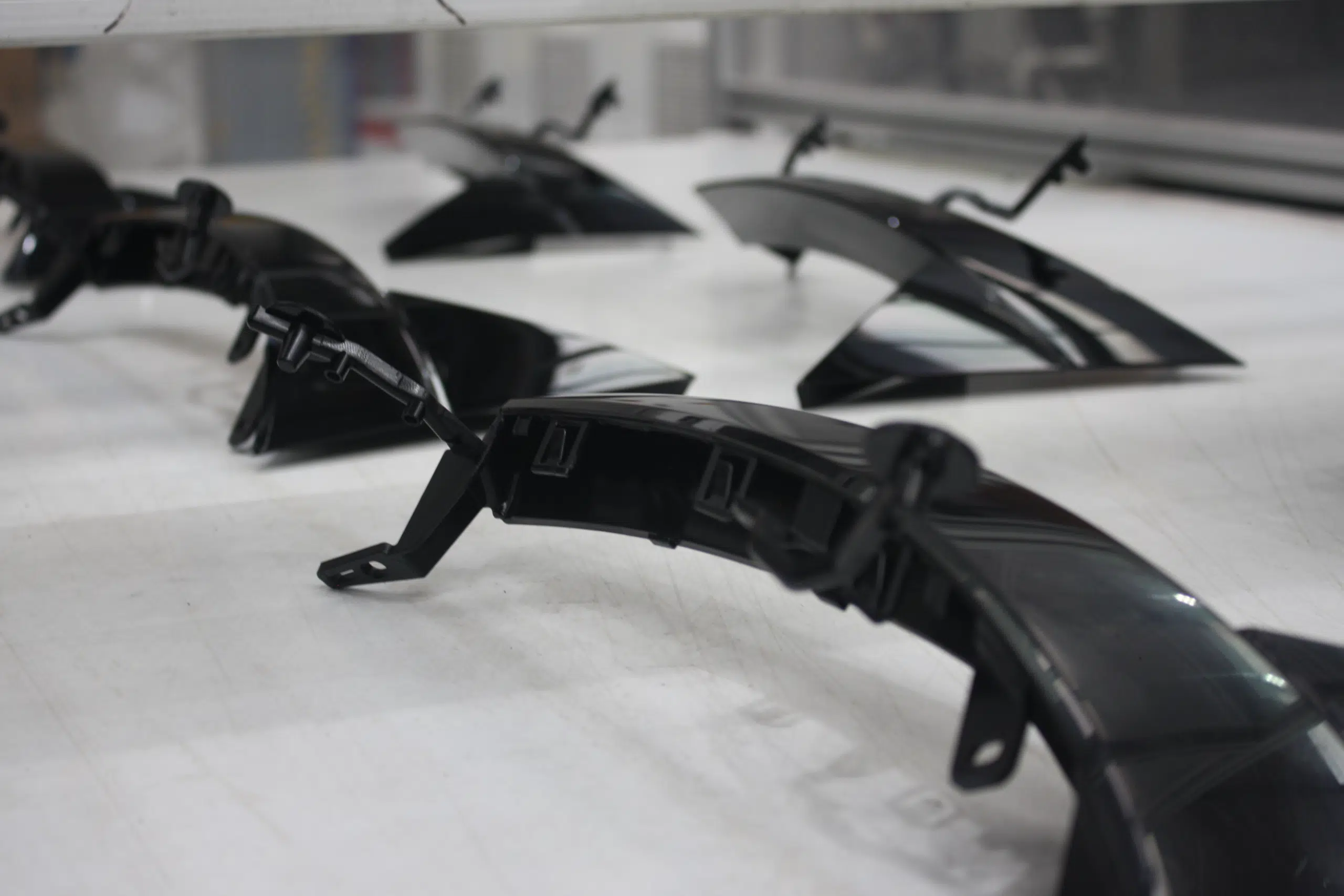 High-quality automotive parts made from durable ABS Plastic on a conveyor belt, showcasing the versatility of ABS Plastic in manufacturing. High-quality automotive parts made from durable ABS Plastic on a conveyor belt, showcasing the versatility of ABS Plastic in manufacturing.