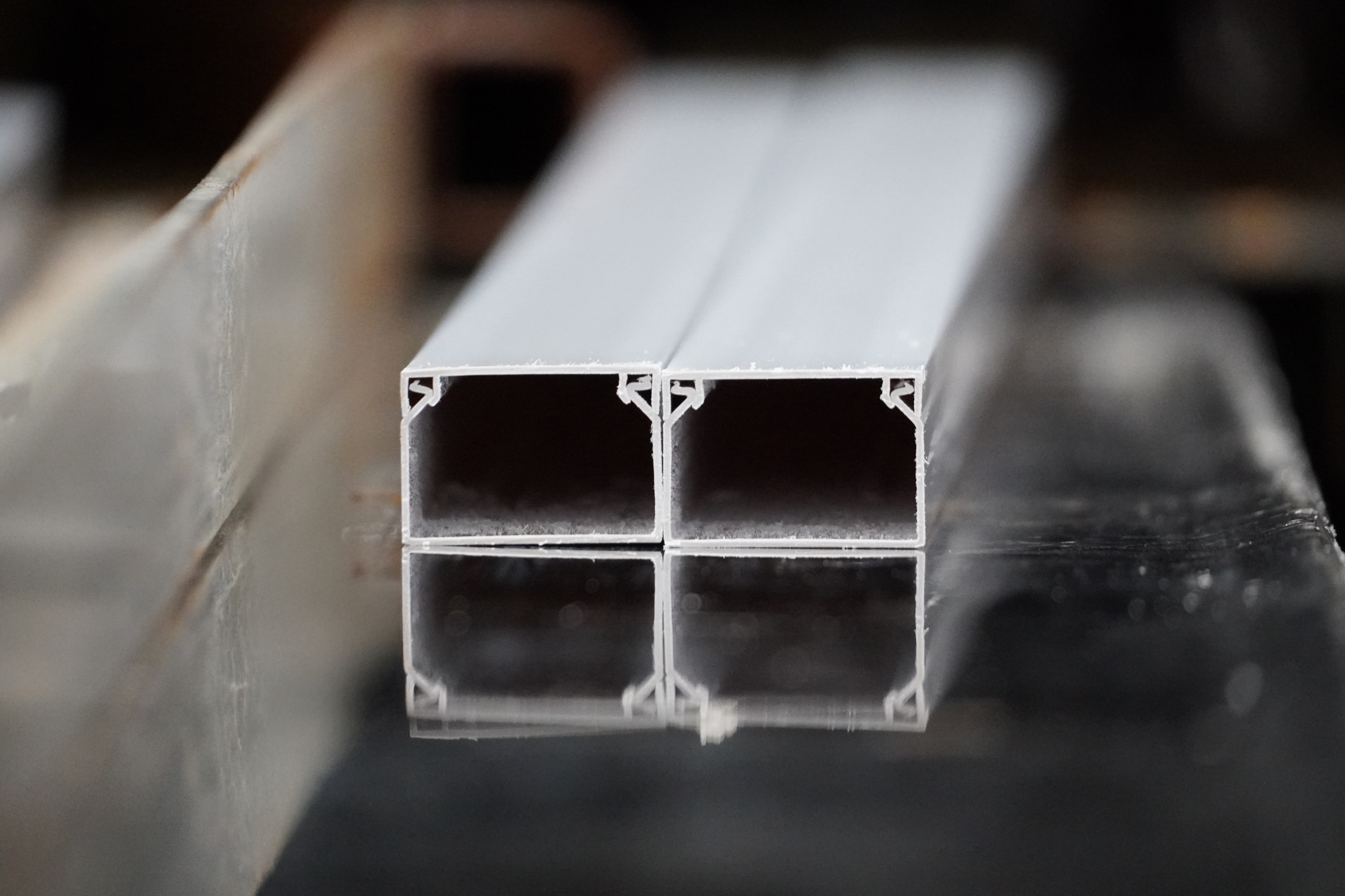 Rigid white PVC extrusion profile on a production line